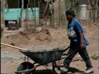 Coco with a wheel barrow of cement