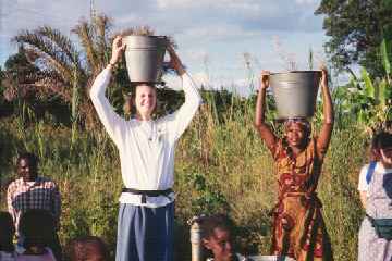 Jill balancing bucket on head